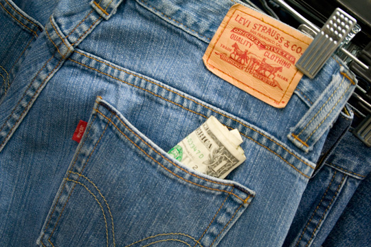 pair of levis with a dollar bill sticking out of back pocket