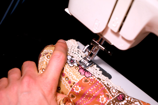 sewing machine stitching the lace of a vintage garment