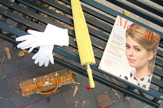vintage accessories and a vintage 1960s mccall magazine on a park bench